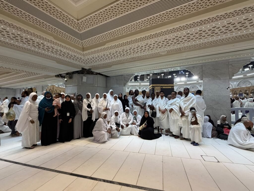 Kasfah Hajj guests taking a group photo near the Kaaba during Umrah