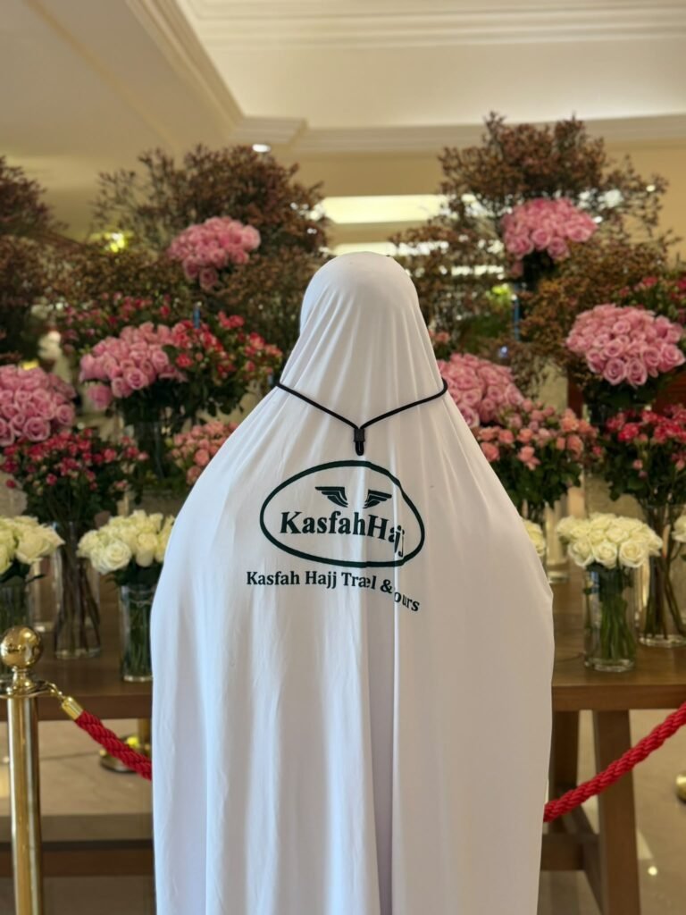 A Kasfah Hajj Umrah guest in the hotel lobby in Makkah, dressed in Kasfah Hajj colours